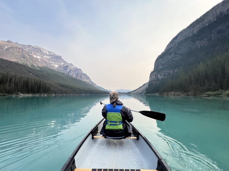 Woman canoeing on Moraine Lake in Banff National Park - a great excursion for your next family travel adventure