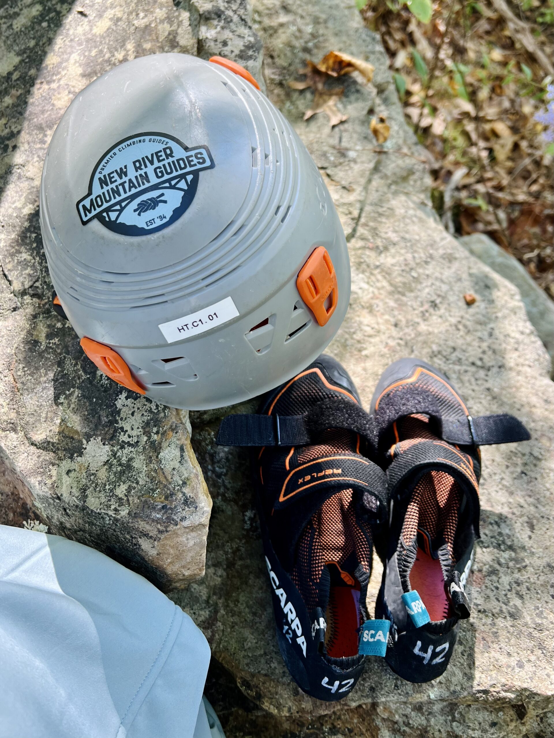 Helmet and shoes for a full-day of guided rock climbing with New River Mountain Guides in New River Gorge National Park.