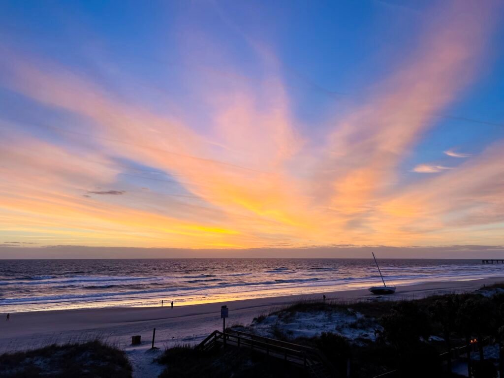 the view of sunrise from our oceanfront balcony room at Courtyard by Marriott Jacksonville Beach, one of the best hotels in Jacksonville Beach