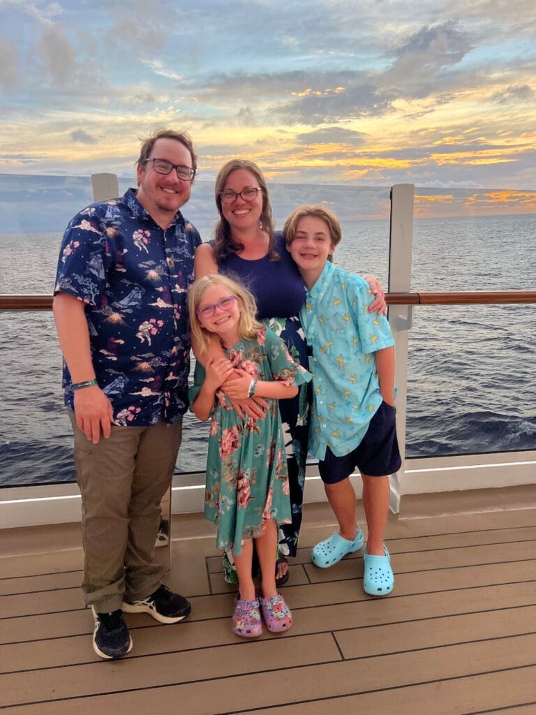 Smiling family on the deck of an MSC cruise ship at sunset