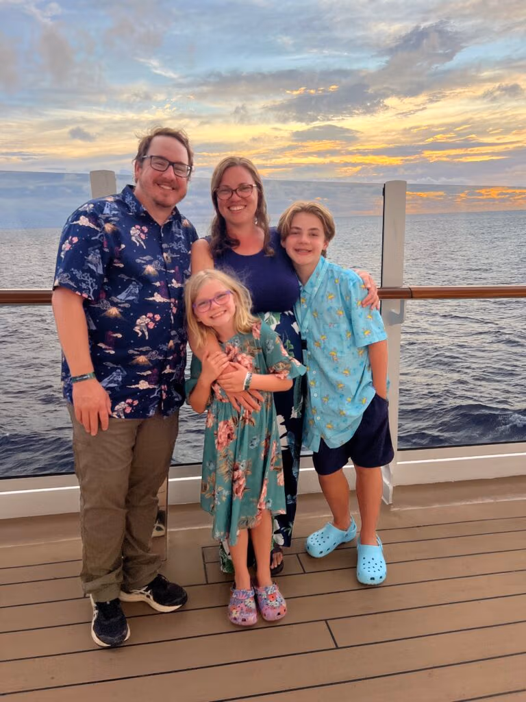 Smiling family on the deck of an MSC cruise ship at sunset